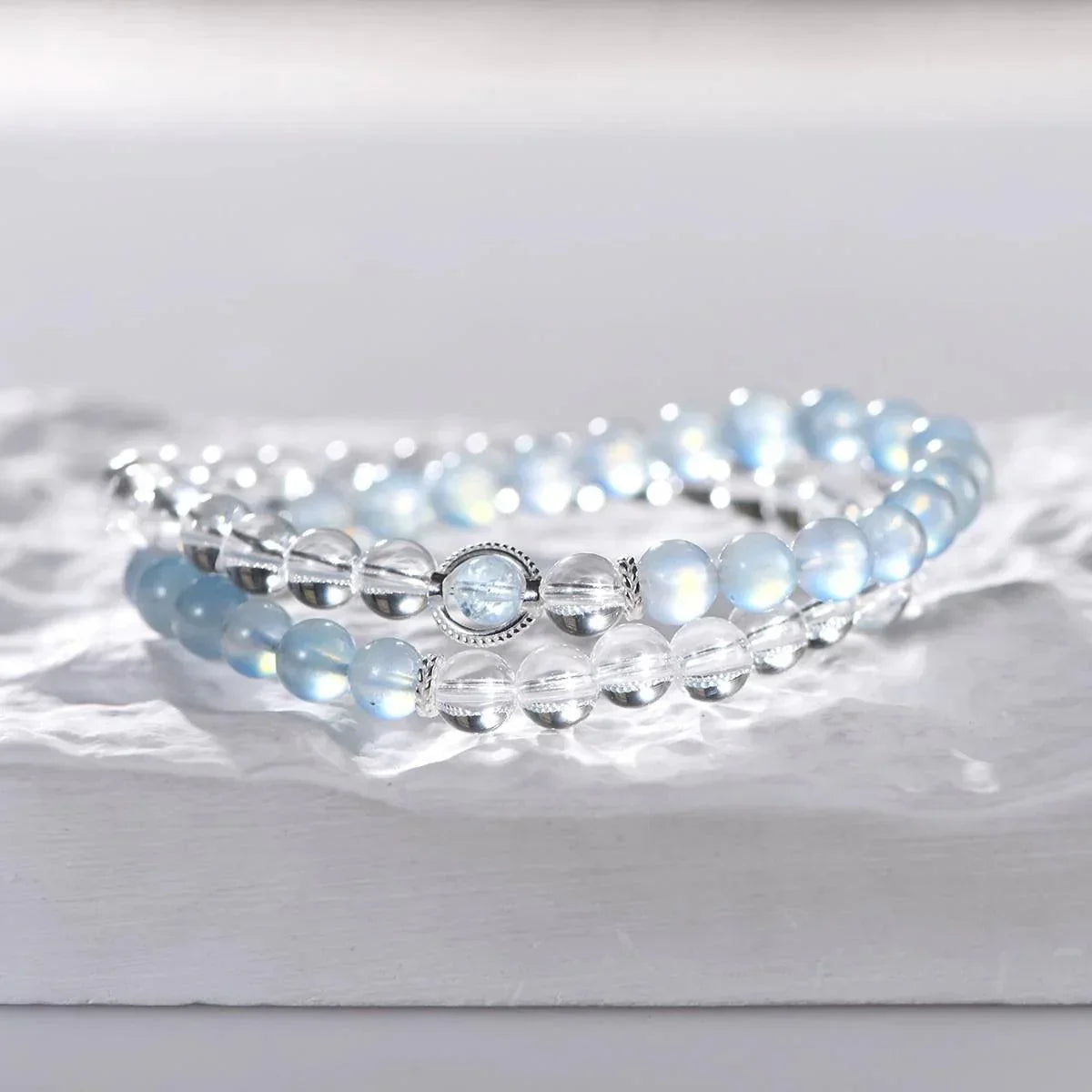 Ocean Breeze double wrap bracelet with clear quartz and aquamarine beads on white textured surface