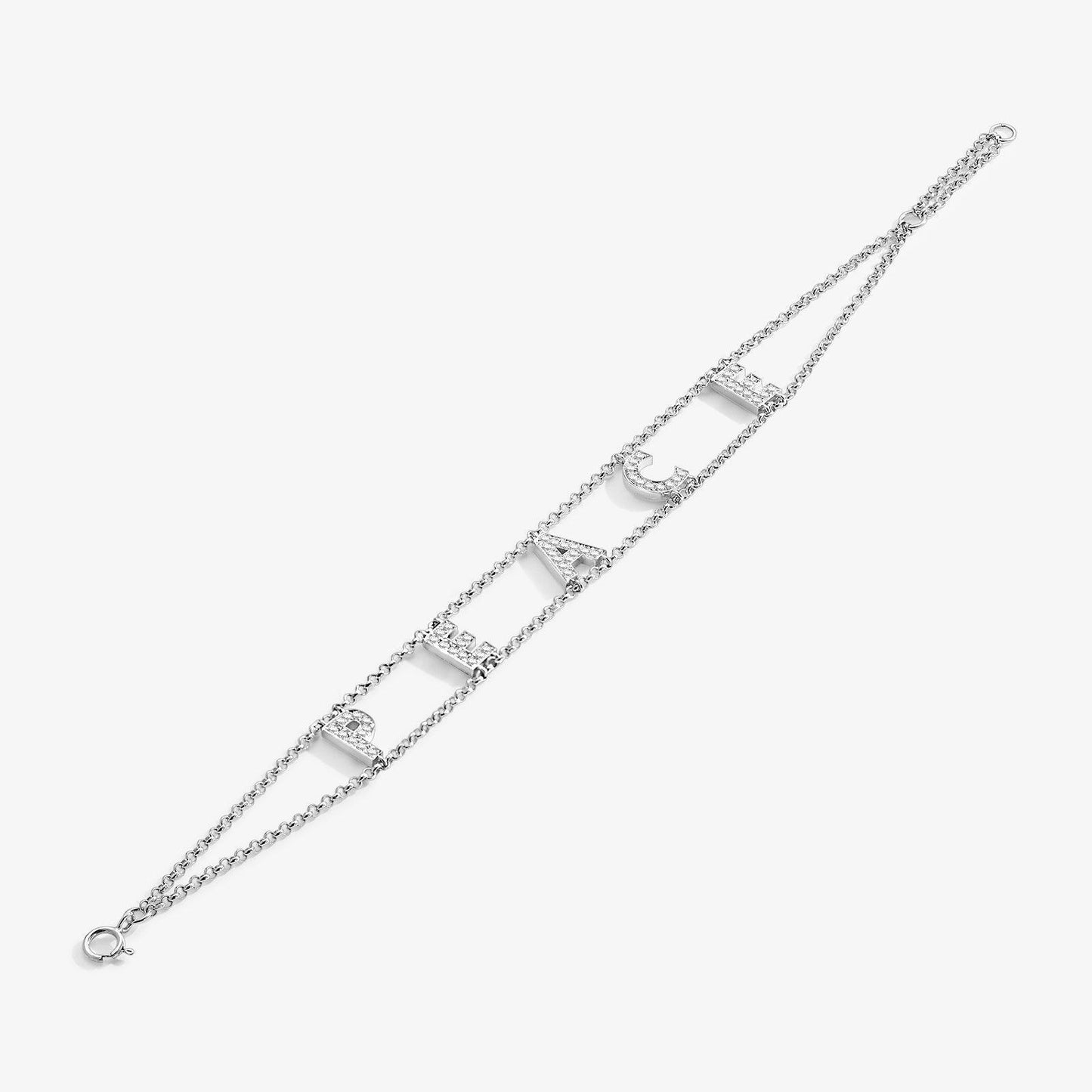 Silver chain bracelet with rhinestone letters spelling PEACE on white background