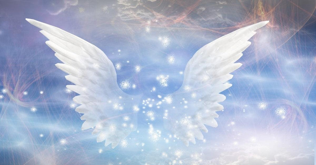Glowing white angel wings against a soft blue and purple celestial background with sparkling lights