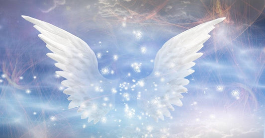 Glowing white angel wings against a soft blue and purple celestial background with sparkling lights