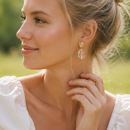 Woman with a bun hairstyle wearing earrings outdoors