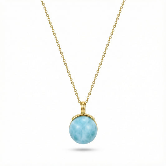 Gold chain necklace with round larimar pendant featuring ocean-like blue stone
