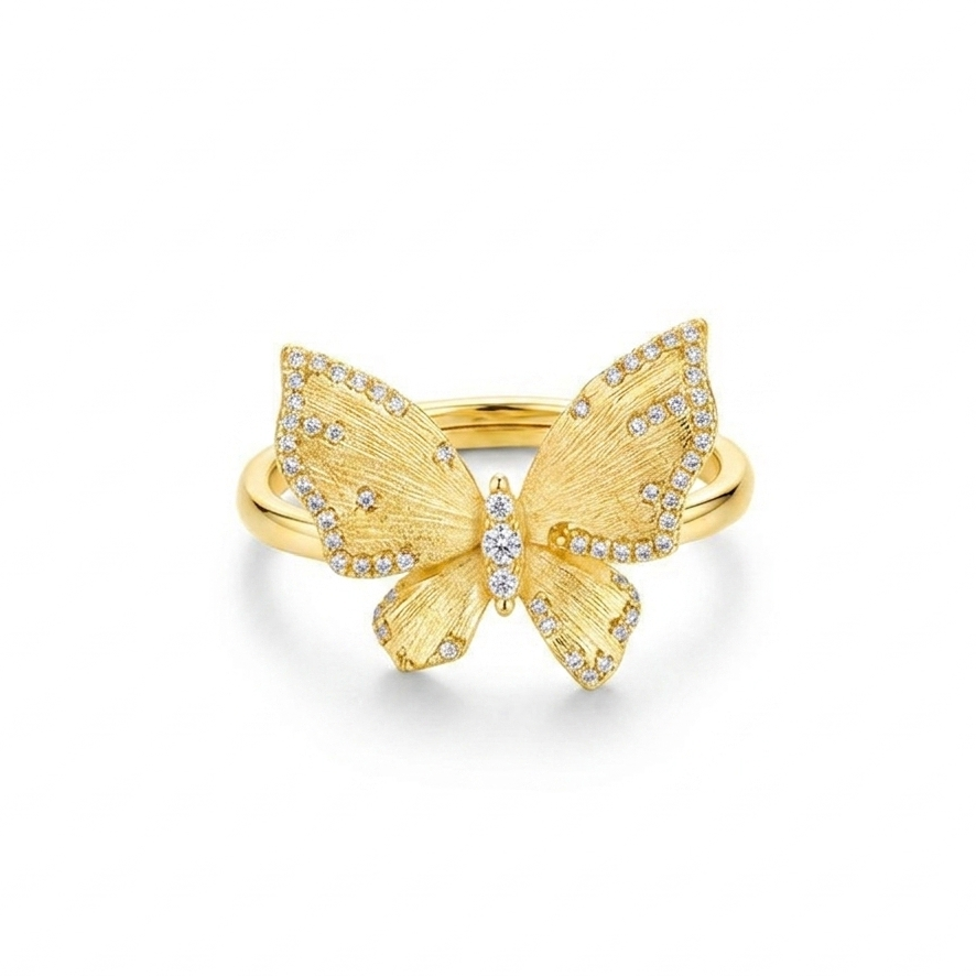 Gold butterfly ring with diamond accents on a white background