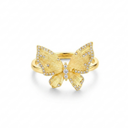 Gold butterfly ring with diamond accents on a white background